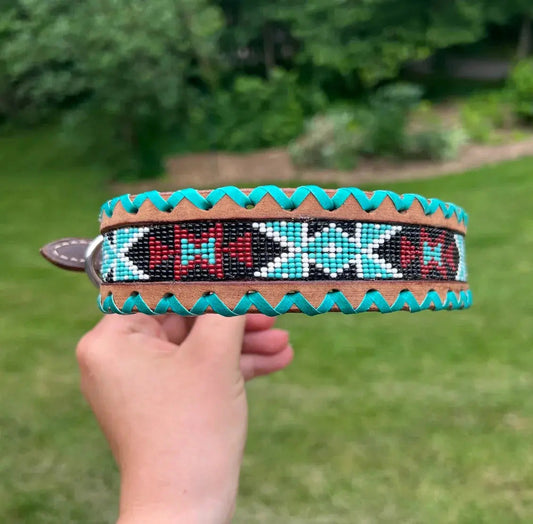 Genuine leather dog collar with teal, white, and burgundy beaded inlay design, a rawhide wrapped edge